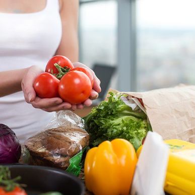 woman holding tomatoes in hands