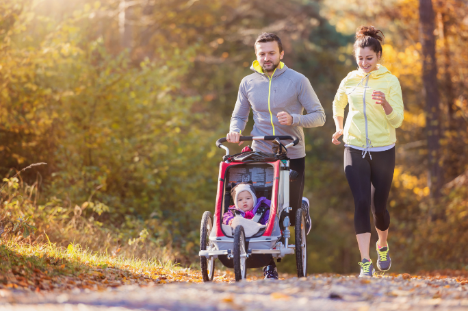 family running while pushing a stroller
