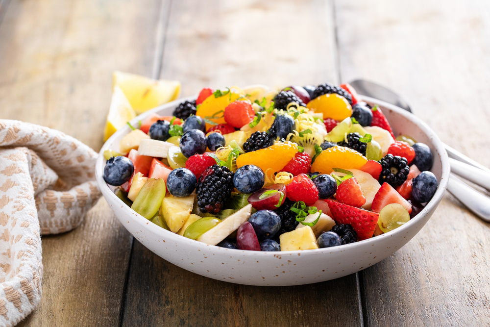 Fruit,Salad,On,A,Wooden,Table,With,Berries,,Citrus,Zest
