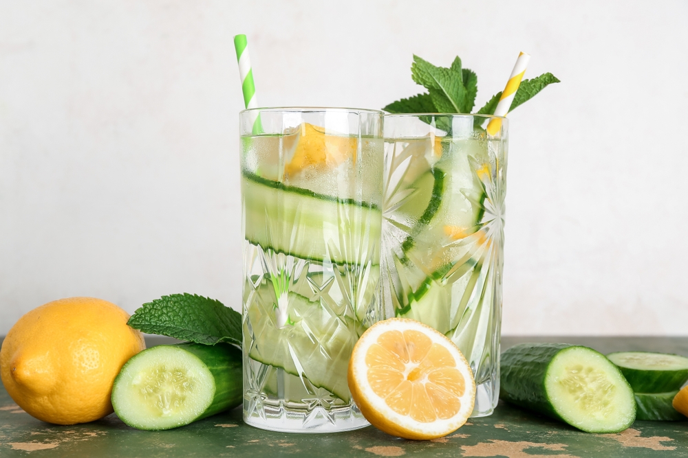 Glasses,Of,Lemonade,With,Cucumber,And,Mint,On,Green,Table
